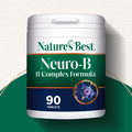 A pot of Nature's Best Neuro B Complex dietary supplement, featuring a green label, placed on a green background.