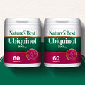 Two containers of Nature's Best Ubiquinol 100mg capsules on a gradient background
