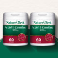 Two containers of Nature's Best Acetyl L-Carnitine 500mg capsules on a green and white background.