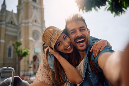 Couple taking a selfie in front of a cathedral