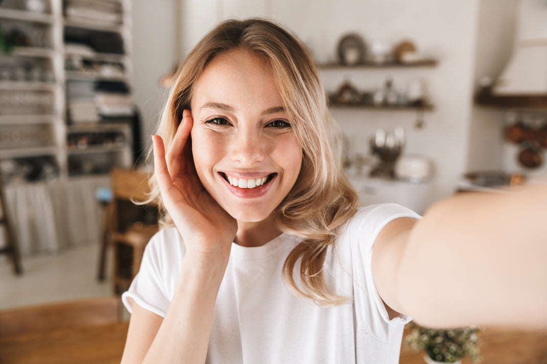 Woman taking a selfie in a kitchen