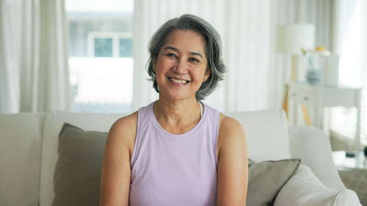Woman sitting on a couch in a bright living room